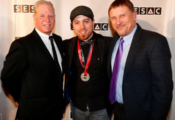 ><figcaption>Pictured (left to right): SESAC’s Pat Collins with Billboard’s Christian Producer of the Year, Seth Mosley and SESAC’s John Mullins.</figcaption></figure>
<figure class=